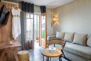 a living room with a couch and a table at Oasis Apartments in Tolo