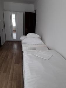 A bed or beds in a room at Halász Vendégház