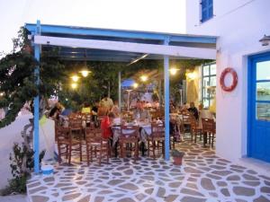a group of people sitting at tables at a restaurant at Argo in Antiparos Town