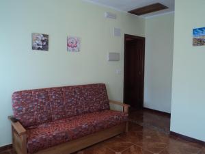 a couch in a room with two pictures on the wall at Apartamentos Rurales Pernús in Colunga