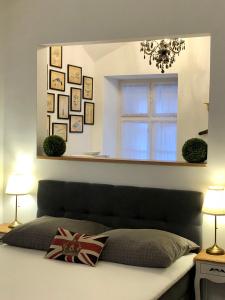 A bed or beds in a room at Frank Apartman Deluxe