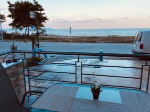 a view of the ocean from a boat with a table at Skoulidis Family Apartments in Nea Vrasna
