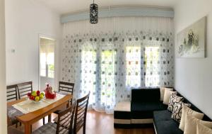 a living room with a table and a window at Evmorfias House in Kallirákhi +12 photos