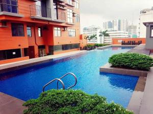 a large swimming pool in the middle of a building at 2 BR Portovita Tower 12-A in Manila