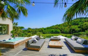 a backyard with a deck with a pool and a table at villa Sant-Anna in Saint-Tropez