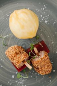 a plate with a piece of food and a roll at Mansion House Llansteffan in Carmarthen