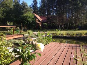 a wooden deck with a house in the background at Villa Leśna in Koszalin