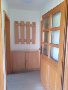 an empty room with a door and a cabinet at Ferienwohnung Fischer in Kurort Gohrisch +1 photo
