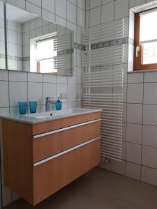 a bathroom with a sink and a mirror at Ferienwohnung Fischer in Kurort Gohrisch
