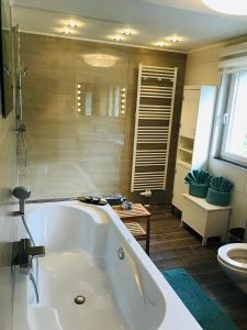 a large bathroom with a tub and a toilet at Berglust Und Seenliebe in Presseggersee