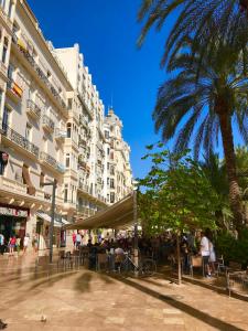 a city street with a palm tree and a building at Alicante Hills Apartment Blue in Alicante