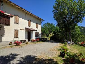 an external view of a farm house with a gravel driveway at Serenella B&B in Sestola