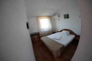 Postel nebo postele na pokoji v ubytování Vila Trandafir