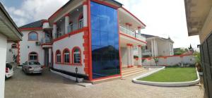 a house with a large glass window on the side of it at Afri-Royal Hotel in Accra