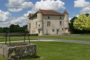 a large house with a large rock in front of it at PETIT GITE EN BRACONNE in La Rochette