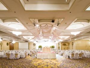 a large banquet hall with white tables and chairs at Montien Riverside Hotel Bangkok in Bangkok +179 photos