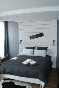 a bedroom with a bed with two white towels on it at Le Chateau de la Barre in Mosnes +24 photos