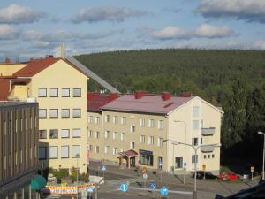 a group of buildings with trees in the background at Piriko Apartments in Rovaniemi