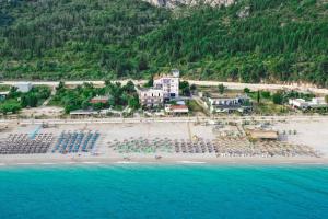 an aerial view of a beach with tables and chairs at Hotel Keisa in Dhërmi