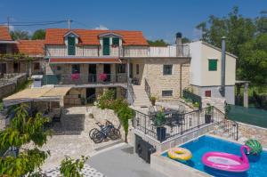 an aerial view of a house with a swimming pool at Holiday home Stipanovi Dvori with jacuzzi and pool in Zagvozd