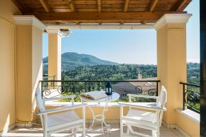 a balcony with a table and chairs and a view at Hilltop Holiday Residence in Corfu Town
