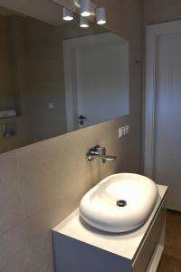 Un baño con un lavabo blanco y un espejo. en Homole Apartament LUX, en Szlachtowa