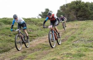 three people riding bikes down a dirt road at Hostel Odorico in San José