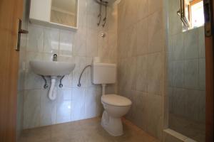 a bathroom with a toilet and a sink at Villa Hortus in Neum +85 photos