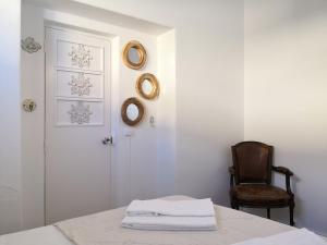 a room with a table and a chair and a door at Be My Neighbour in Lisbon