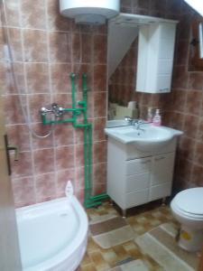 a bathroom with a toilet and a sink and a shower at Green Idylle -Pyramid View in Visoko