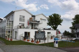 a white building with a sign in front of it at Appartement Nr 7 im Sonnenbad in Sassnitz