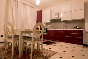 a kitchen with a dining room table and chairs at Hotel Pandora Residence in Tirana