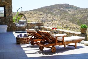 a couple of chairs and a table on a patio at Elia Horizon Mykonos in Elia Beach