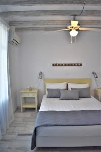 A bed or beds in a room at Arsinoi Apartments