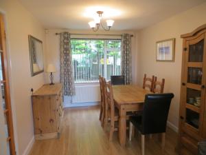 a dining room with a table and chairs and a window at River View in Coleraine