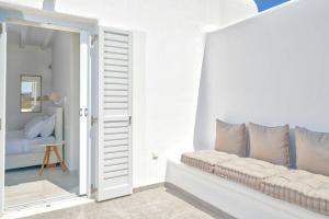 a white room with a couch and a window at Elia Horizon Mykonos in Elia Beach