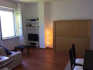 a living room with a couch and a television at Bellagio Dream in Valbrona