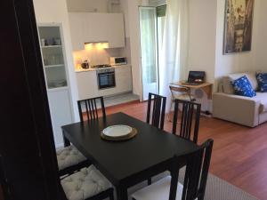 a dining room and living room with a table and chairs at Bellagio Dream in Valbrona