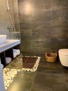 a bathroom with a shower and a toilet and a sink at Kanes Boutique Hotel in Sarandë