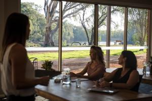 a group of women sitting at a table in a restaurant at Cadell On The Murray Motel in Moama