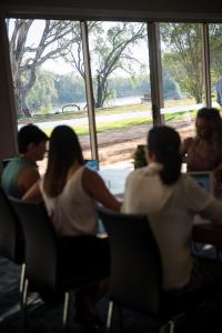 people sitting in chairs at a table at Cadell On The Murray Motel in Moama