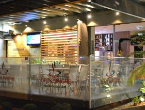ein Restaurant mit Tischen und Stühlen in einem Raum in der Unterkunft Hotel Maione in Goiânia