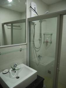 a white bathroom with a sink and a shower at Trillium Residences Ayala Cebu in Cebu City +42 photos