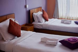 Postel nebo postele na pokoji v ubytování Bodhi Guest House