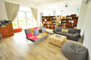 a living room with a couch and a table at Sea Daughter's Homestay in Huxi