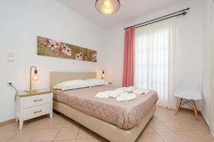 a bedroom with a bed and a table and a window at Antonia Studios in Naxos Chora