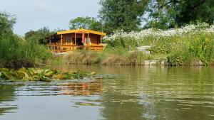 a house sitting on the side of a river at East Pool Cabin in Lincoln