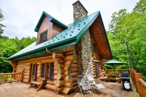 a log cabin with a patio and a roof at Domaine la Cedriere in Grenville-sur-la-Rouge