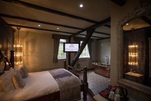 a bedroom with a bed and a tub in it at Bowburn Hall Hotel in Durham