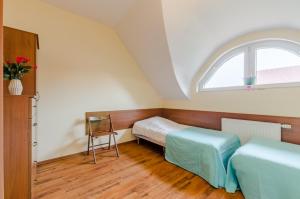 a room with two beds and a window at Willa Rowy in Rowy
